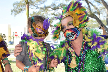 little girl and employee at mardi gras event 2021