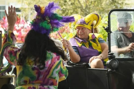 Mardi Gras car parade images with man and woman in costume