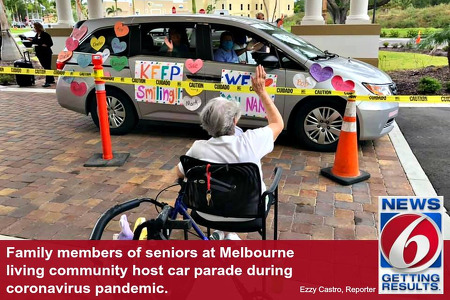 Woman in wheelchair waving to family in a van
