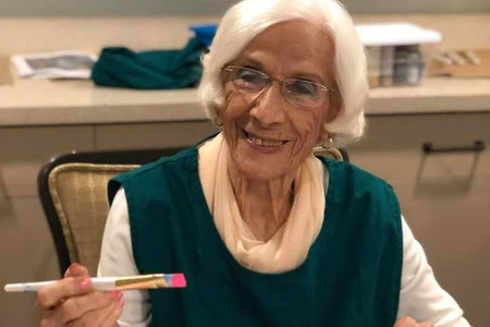 Senior Woman Painting a Pink Starfish