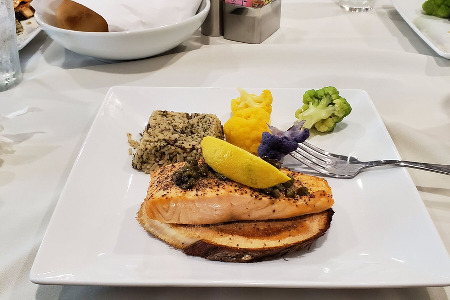 Salmon on wood plank with sides