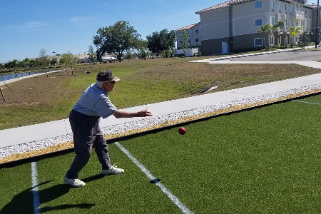 Older man throwing baachi ball
