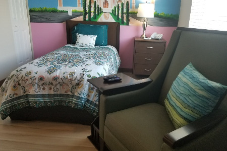 Living area with bed, end table and chair