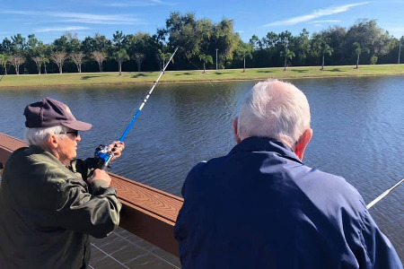 2 older men fishing on a lake