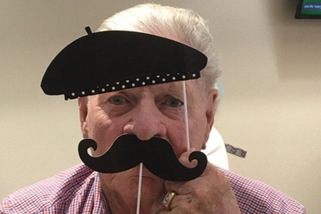 Happy Resident with Fake Beret and Mustache