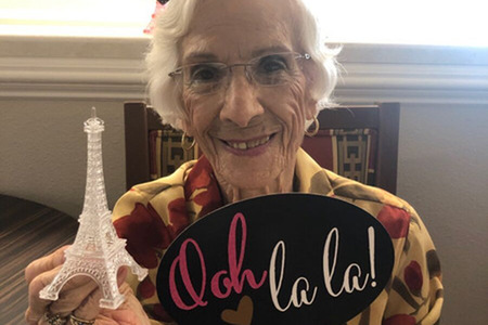 Happy Resident Holding an Ooh La La Sign