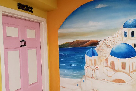 A mural of Greece and a pink door