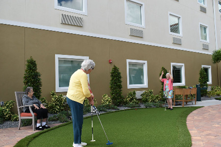 Older woman playing mini-golf