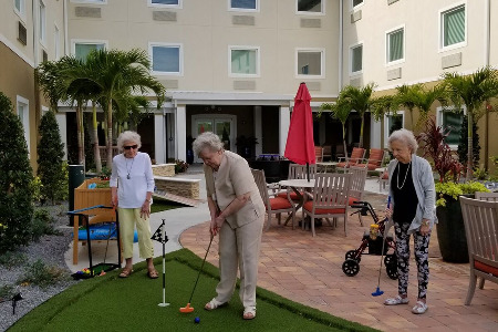 Seniors playing mini-golf