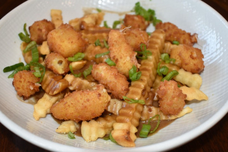Poutine - French fries topped with brown gravy and cheese curds